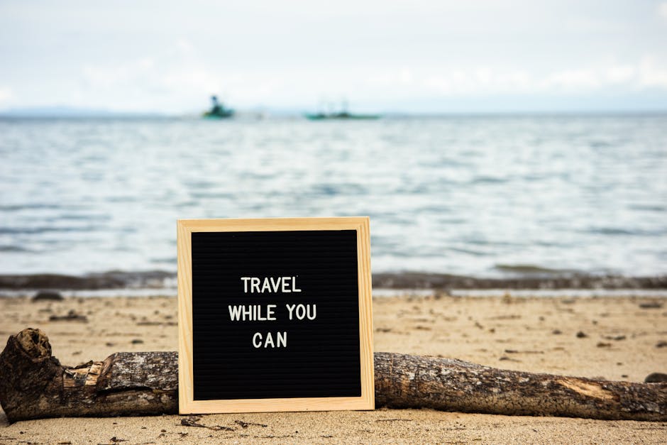 Letter board with travel quote on scenic beach background, inspiring wanderlust.
