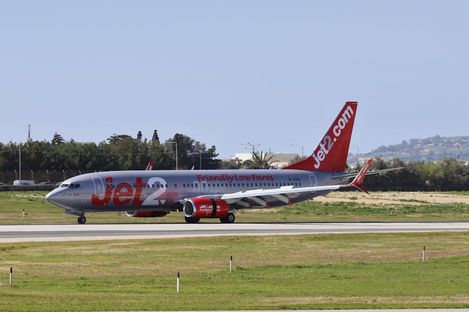 Jet2 airplane on runway with clear sky backdrop, ready for takeoff.